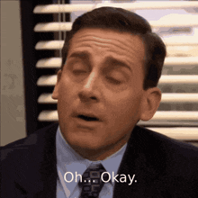 a man in a suit and tie says " oh okay "