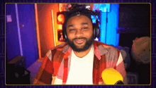 a man with a beard wearing headphones and a headband with the letter r on it