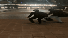 a man is pushing another man while holding a bag