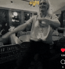 a black and white photo of a woman dancing in a room with the words night written above her