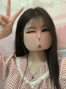 a girl in a plaid shirt is making a face with her mouth
