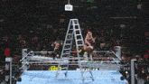 a wrestling ring with a ladder in the middle and a sign that says monster energy