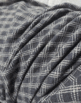 a close up of a blanket with a plaid pattern on it