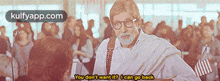 a man with glasses is standing in front of a crowd and says " you don t want it ? i can go back "