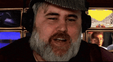 a man with a beard is wearing headphones in front of a screen that says 00000