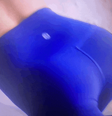 a close up of a person 's butt in blue leggings