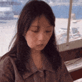 a close up of a woman 's face with her eyes closed in front of a window
