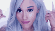 ariana grande is wearing a wig and making a face .
