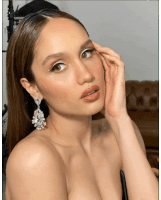 a close up of a woman 's face with a hand on her face