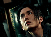 a close up of a man 's face looking up at the sky