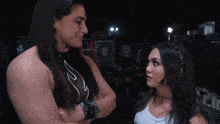 two women are standing next to each other with their arms crossed and one has a choker around her neck