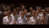 a group of people are standing in a line and one of them says no not you i mean