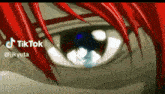 a close up of a person 's eye with a tiktok logo behind it