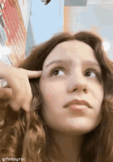 a close up of a woman 's face with the words gifsdayrol on the bottom right