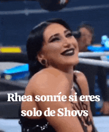 a woman is smiling in a wrestling ring and the caption says rhea sonrie si eres solo de shows