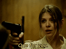 a woman pointing a gun with the words one for you written below her