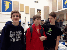 a boy wearing a franklin middle school shirt stands next to another boy wearing a berlin shirt