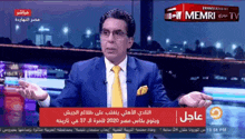 a man in a suit and tie is talking on a television screen with a red box that says memri tv