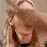 a close up of a woman 's face with a hand on her face