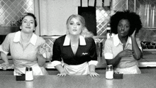 a black and white photo of three waitresses one of whom has a name tag that says meghan