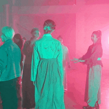 a blurry picture of a group of people dancing in a room