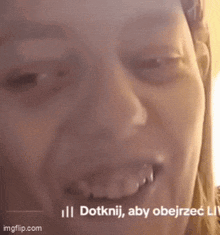 a close up of a woman 's face with a caption that says dotknij aby obejrzec lit