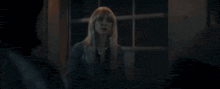 a blurry picture of a person in a blue jacket