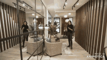 a woman is standing in a room with the words made in animatica on the bottom right