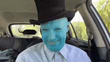 a man with blue paint on his face and a top hat