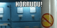 a no smoking sign is in front of a blue wall with the words horrudu