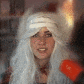 a woman wearing a white wig and a furry hat