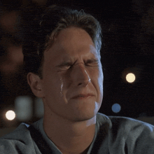 a man is crying with a tear running down his cheek