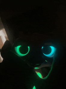 a person 's face is glowing in the dark and looks like toothless from how to train your dragon