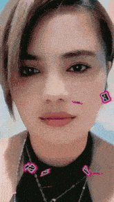 a close up of a woman 's face with stickers on her face including one that says a