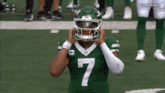 a football player wearing a green jersey with the number 7