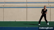 a woman is playing tennis on a court with make a gif.com in the lower right corner