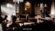 a man sits on a couch in a living room with the words " don 't start nik " on the bottom