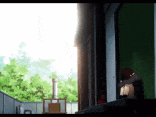 a person is sitting on a balcony with their head in their hands .