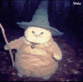 a stuffed owl wearing a wizard hat and holding a wand