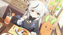a girl sitting at a table with a plate of food