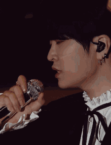 a close up of a person holding a microphone in their hand