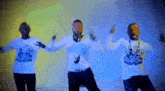 three men wearing white shirts with the word pepsi on them are dancing together