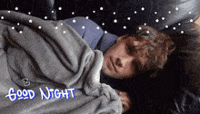 a young man is sleeping under a blanket with the words good night written on the bottom