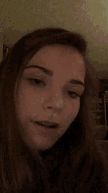 a girl with her eyes closed is sitting on a couch