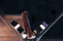 a hot dog with a wooden handle is sitting on a table