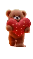a brown teddy bear is holding a red heart