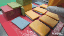 a bunch of different colored blocks are stacked on top of each other with the words made in animotica in the corner