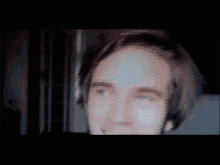a blurry image of a man 's face with a striped background