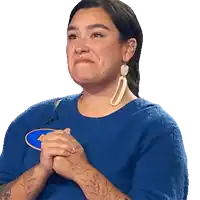 a woman wearing a blue shirt with a house on it is smiling
