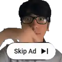 a man wearing glasses is pressing a skip ad button .